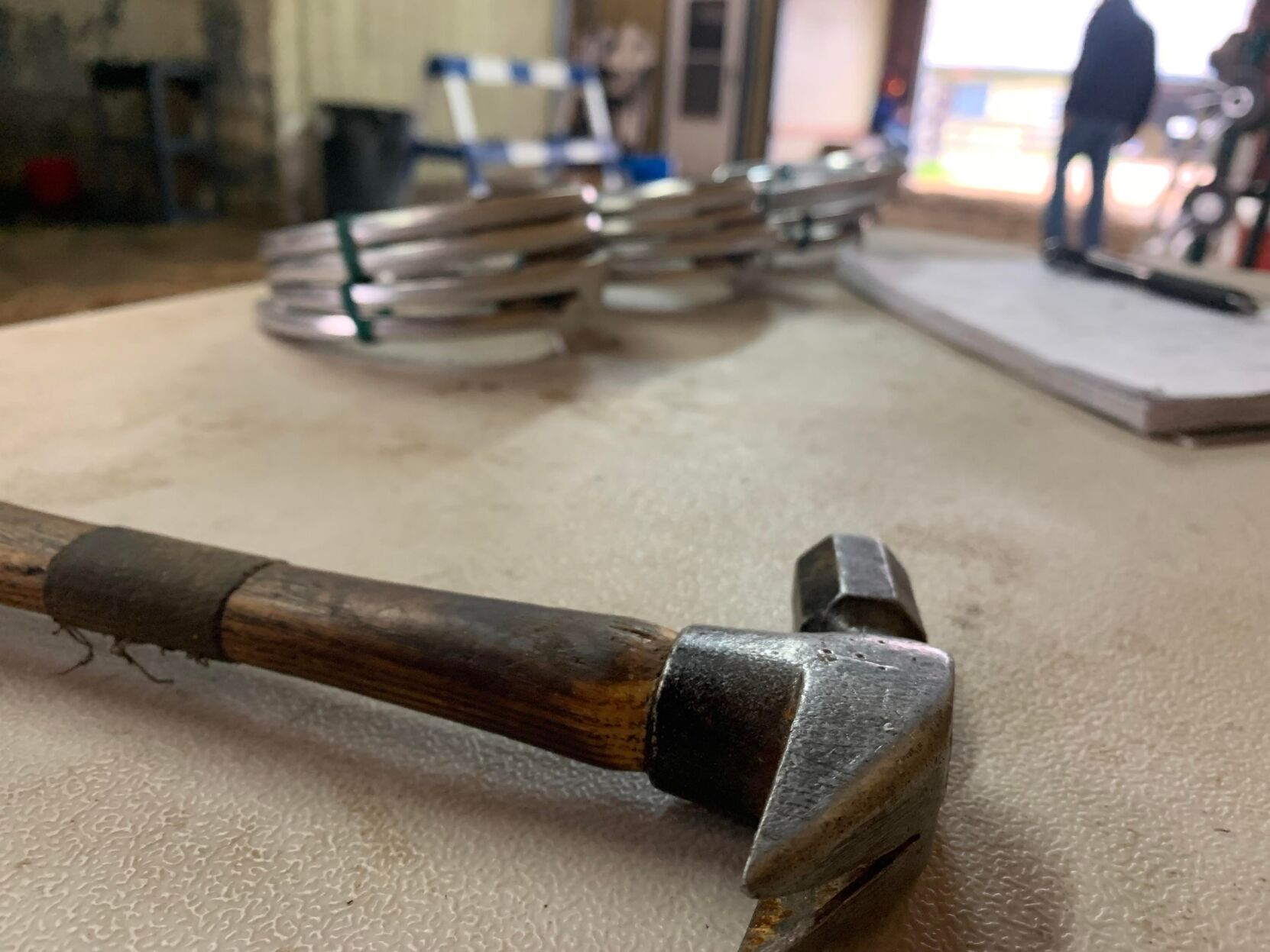 Hammer with new horseshoes on table